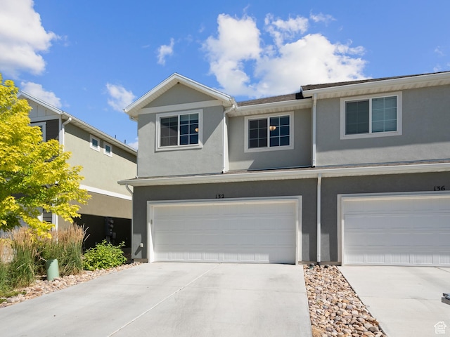 132 E Geyser Ct, Saratoga Springs, UT 84045 - view of front of property featuring an attached garage, concrete driveway, and stucco siding