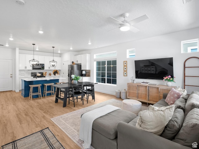 132 E Geyser Ct, Saratoga Springs, UT 84045 - living room featuring a ceiling fan, light wood-style flooring, plenty of natural light, and recessed lighting