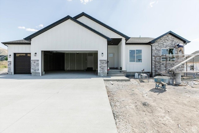 880 E 130 N, Hyde Park, UT 84318 - modern farmhouse style home with a garage, board and batten siding, and concrete driveway