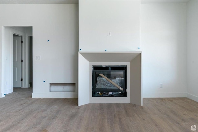 880 E 130 N, Hyde Park, UT 84318 - unfurnished living room featuring wood finished floors and a glass covered fireplace