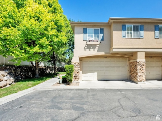 3908 W Lorient Ave, West Jordan, UT 84084 - view of front of property with an attached garage, stucco siding, and stone siding