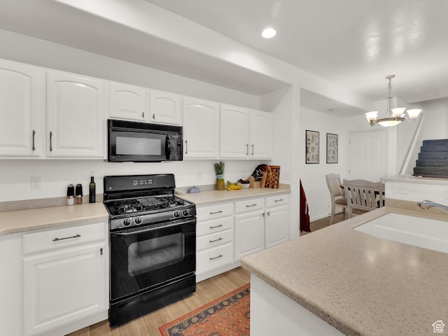 3908 W Lorient Ave, West Jordan, UT 84084 - kitchen featuring black appliances, light wood-style flooring, a chandelier, white cabinetry, and recessed lighting