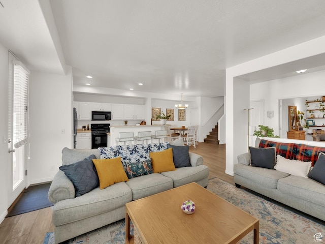 3908 W Lorient Ave, West Jordan, UT 84084 - living room featuring light wood-style floors, stairs, recessed lighting, and a chandelier