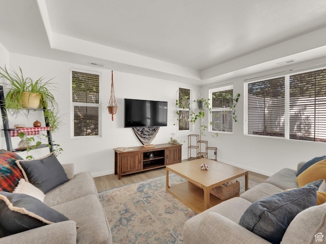 3908 W Lorient Ave, West Jordan, UT 84084 - living room featuring a tray ceiling and light wood-type flooring