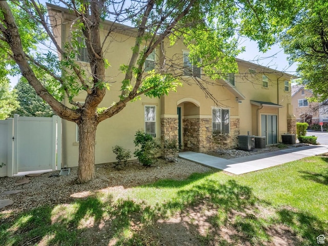 3908 W Lorient Ave, West Jordan, UT 84084 - view of front facade featuring stucco siding, stone siding, and a gate