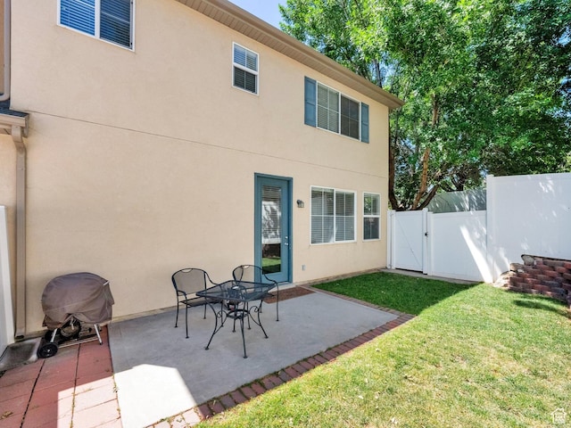 3908 W Lorient Ave, West Jordan, UT 84084 - back of property featuring a gate, a patio area, and stucco siding
