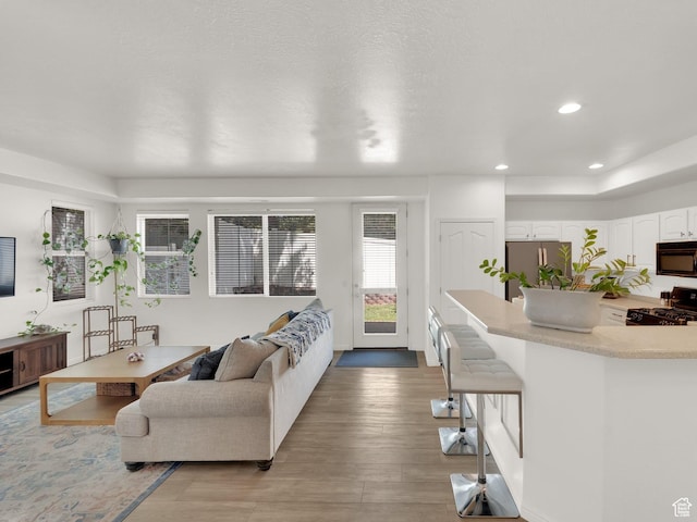 3908 W Lorient Ave, West Jordan, UT 84084 - living room featuring light wood finished floors and recessed lighting