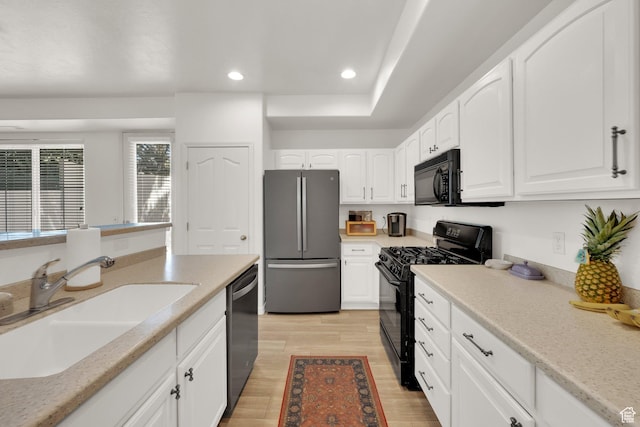 3908 W Lorient Ave, West Jordan, UT 84084 - kitchen with black appliances, white cabinets, recessed lighting, and light wood finished floors