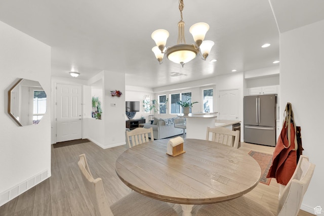 3908 W Lorient Ave, West Jordan, UT 84084 - dining area featuring a chandelier, light wood-type flooring, and recessed lighting