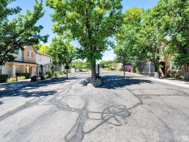 3908 W Lorient Ave, West Jordan, UT 84084 - view of asphalt street with a gated entry, a gate, and curbs