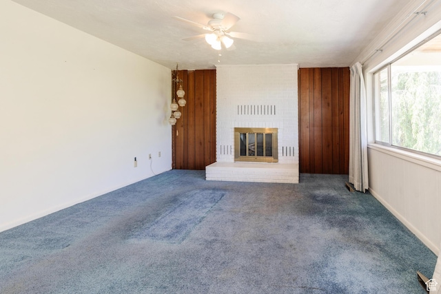 85 E 500 S, Providence, UT 84332 - unfurnished living room featuring ceiling fan, carpet floors, a brick fireplace, and wooden walls