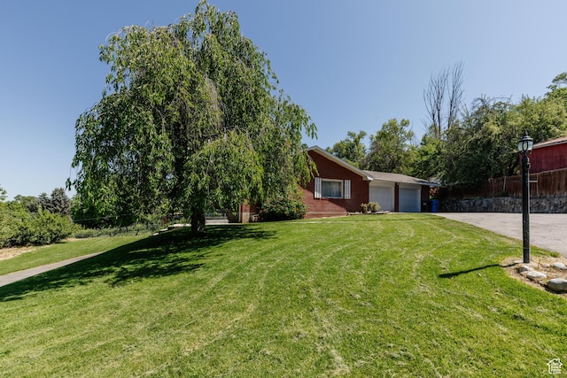 85 E 500 S, Providence, UT 84332 - view of front of house with an attached garage, driveway, and brick siding