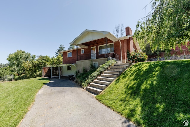 85 E 500 S, Providence, UT 84332 - view of front facade with asphalt driveway, covered porch, a chimney, brick siding, and stairs