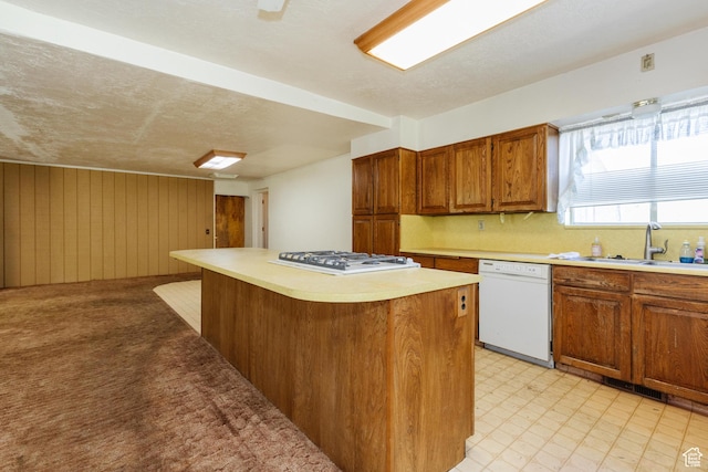 85 E 500 S, Providence, UT 84332 - kitchen with white dishwasher, gas cooktop, light countertops, a kitchen island, and brown cabinets