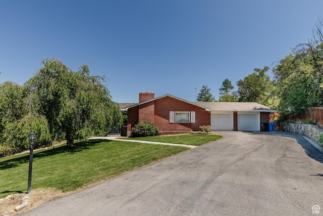 85 E 500 S, Providence, UT 84332 - ranch-style home with an attached garage, brick siding, a chimney, and asphalt driveway