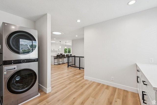 932 W Walden Meadows Dr S, Salt Lake City, UT 84123 - laundry room with estacked washer and dryer, light wood finished floors, and recessed lighting