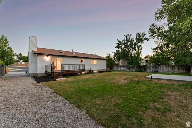 932 W Walden Meadows Dr S, Salt Lake City, UT 84123 - rear view of house featuring a fenced backyard, a wooden deck, and a chimney