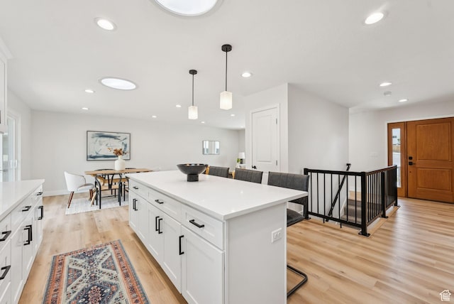 932 W Walden Meadows Dr S, Salt Lake City, UT 84123 - kitchen featuring a breakfast bar area, a kitchen island, hanging light fixtures, recessed lighting, and light countertops