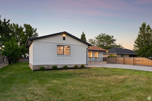 932 W Walden Meadows Dr S, Salt Lake City, UT 84123 - view of front of house featuring a fenced backyard, a patio area, and brick siding
