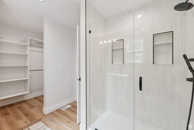 932 W Walden Meadows Dr S, Salt Lake City, UT 84123 - full bathroom with a stall shower, wood finished floors, and a walk in closet