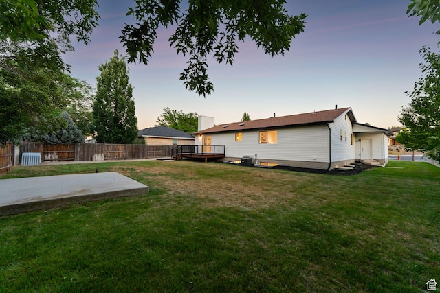 932 W Walden Meadows Dr S, Salt Lake City, UT 84123 - yard at dusk with a wooden deck and a patio