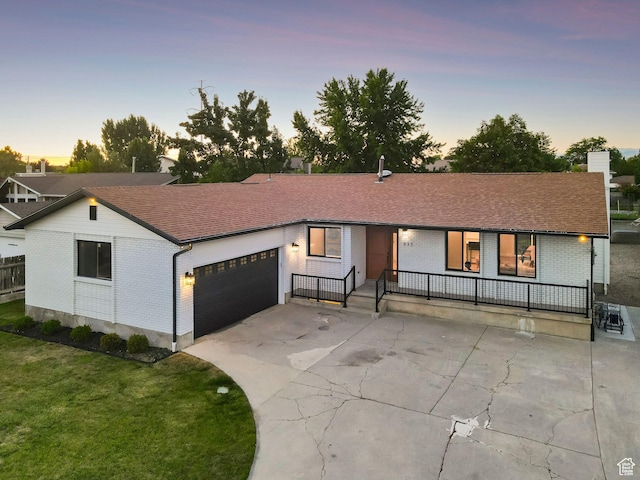 932 W Walden Meadows Dr S, Salt Lake City, UT 84123 - view of front of home featuring brick siding, a garage, covered porch, and driveway