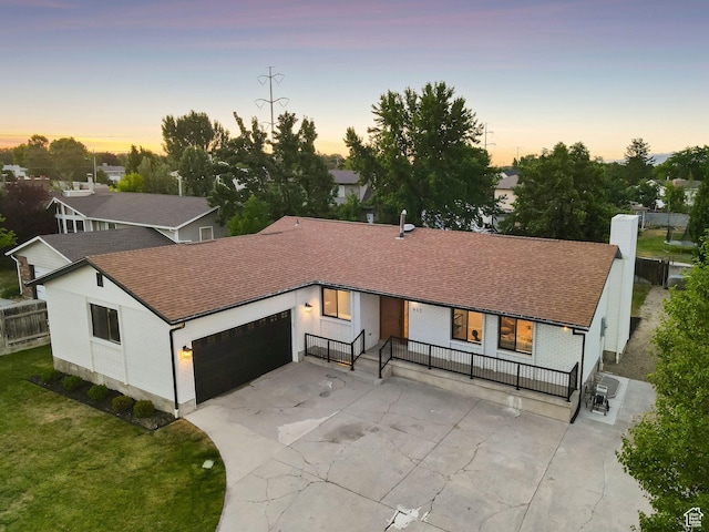 932 W Walden Meadows Dr S, Salt Lake City, UT 84123 - view of front of house featuring an attached garage, driveway, a shingled roof, and a chimney