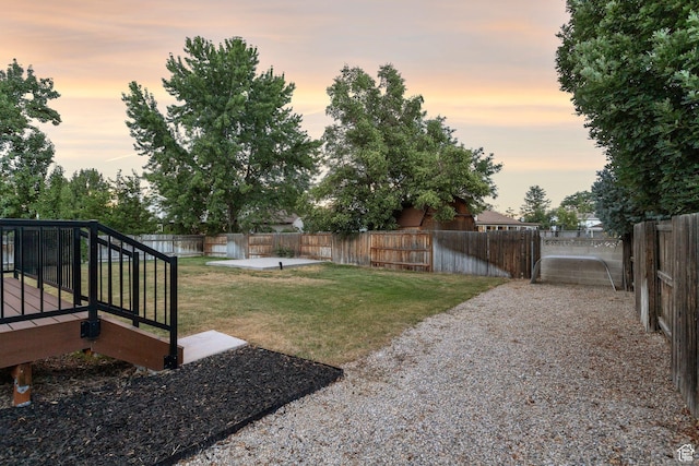 932 W Walden Meadows Dr S, Salt Lake City, UT 84123 - yard at dusk with a fenced backyard and a wooden deck