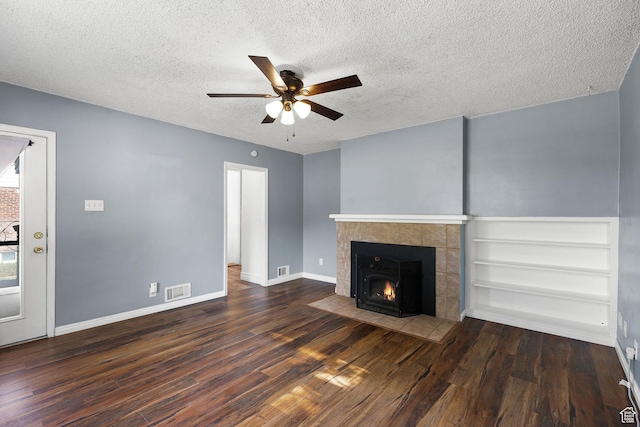 437 E 100 N, Brigham City, UT 84302 - unfurnished living room with a ceiling fan, wood finished floors, a textured ceiling, and a tiled fireplace