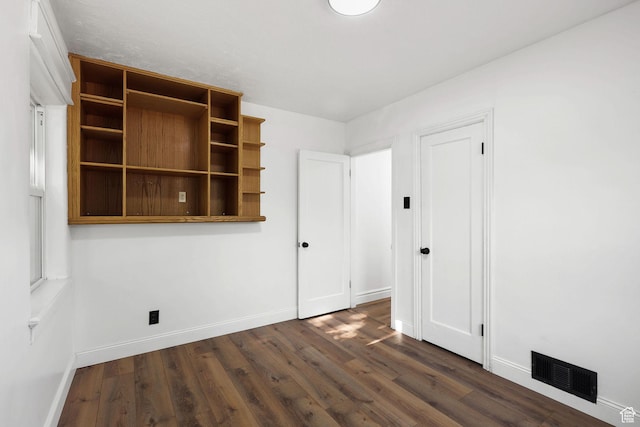 437 E 100 N, Brigham City, UT 84302 - unfurnished bedroom with baseboards and dark wood-style flooring