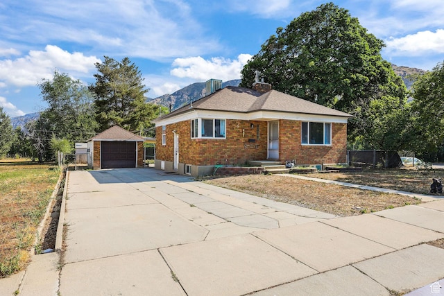 437 E 100 N, Brigham City, UT 84302 - bungalow-style house featuring brick siding, an outbuilding, a garage, and a mountain view