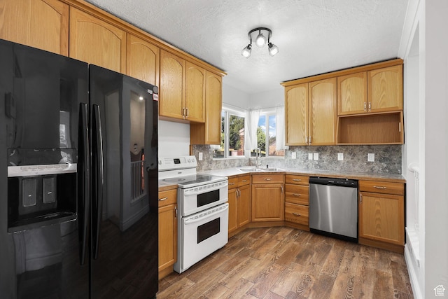 437 E 100 N, Brigham City, UT 84302 - kitchen featuring black fridge with ice dispenser, stainless steel dishwasher, range with two ovens, tasteful backsplash, and a textured ceiling