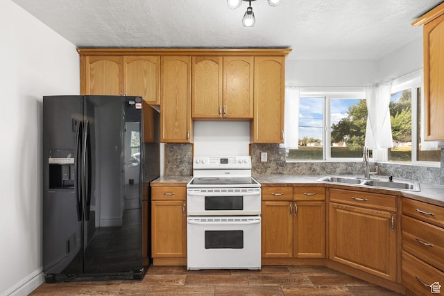 437 E 100 N, Brigham City, UT 84302 - kitchen featuring black fridge with ice dispenser, double oven range, decorative backsplash, dark wood-style floors, and light countertops