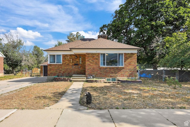 437 E 100 N, Brigham City, UT 84302 - bungalow-style house with brick siding, a chimney, and roof with shingles
