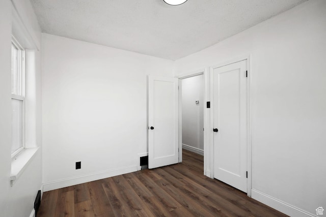 437 E 100 N, Brigham City, UT 84302 - unfurnished bedroom with dark wood-style floors and baseboards