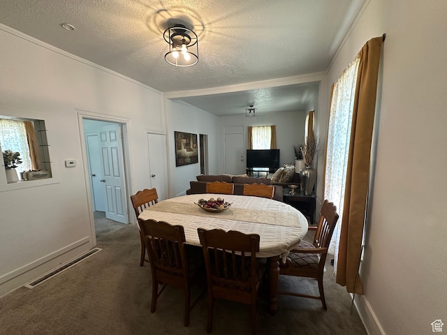2019 Adams Ave, Ogden, UT 84401 - dining space featuring dark carpet, ornamental molding, and a textured ceiling
