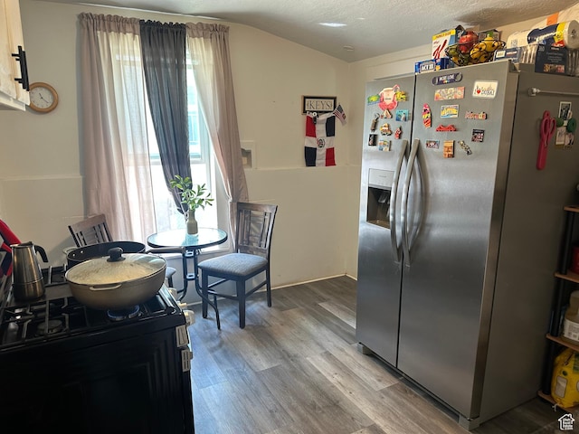 2019 Adams Ave, Ogden, UT 84401 - dining room with light wood-style flooring and vaulted ceiling