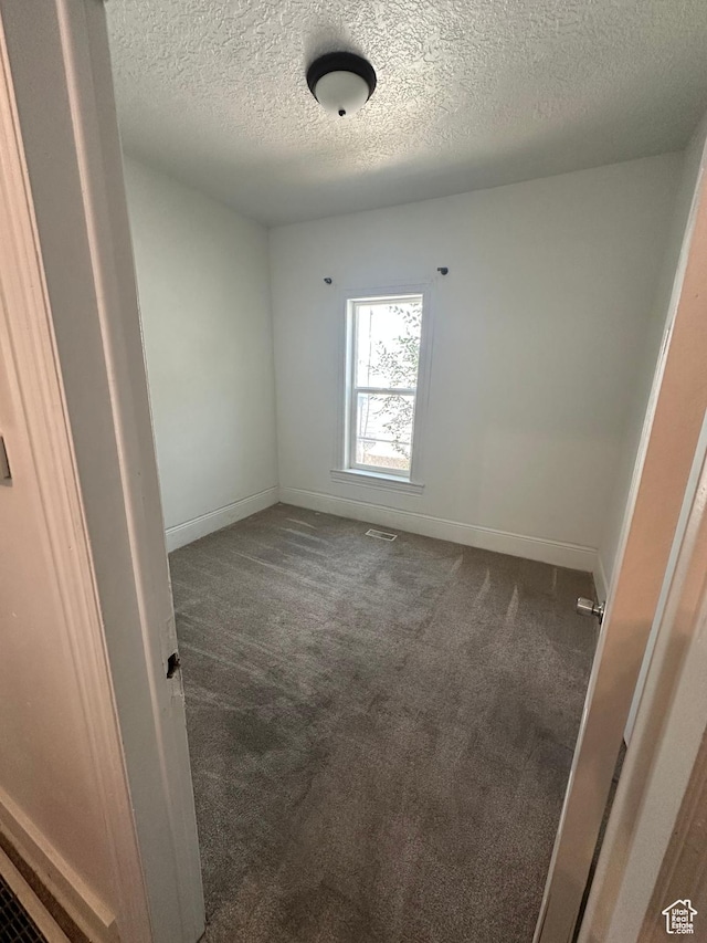 2019 Adams Ave, Ogden, UT 84401 - empty room with carpet floors and a textured ceiling