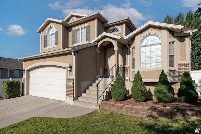 4022 S 2725 W, Roy, UT 84067 - view of front of home with a garage, concrete driveway, stucco siding, and brick siding