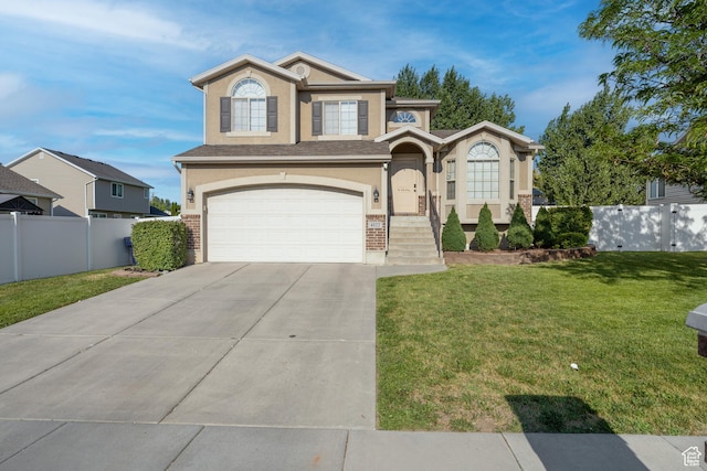 4022 S 2725 W, Roy, UT 84067 - view of front of home featuring stucco siding, a garage, driveway, and brick siding
