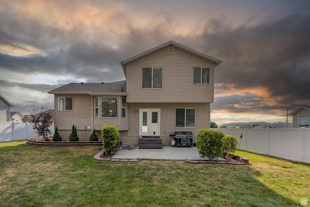 4022 S 2725 W, Roy, UT 84067 - back of house at dusk featuring a patio, a fenced backyard, and entry steps