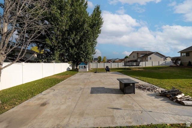 4022 S 2725 W, Roy, UT 84067 - fenced backyard featuring a trampoline, a patio area, and a residential view