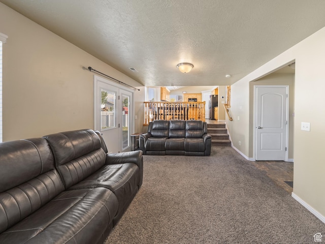 4022 S 2725 W, Roy, UT 84067 - living area featuring dark carpet, stairway, and a textured ceiling