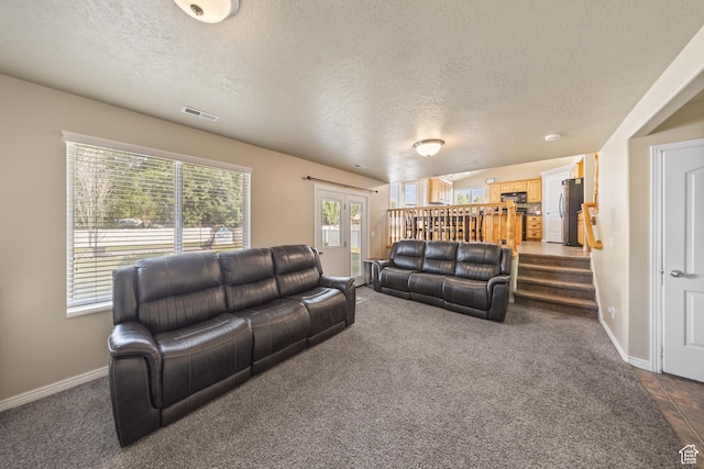 4022 S 2725 W, Roy, UT 84067 - living room with a textured ceiling, dark carpet, and stairs