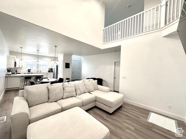 4542 Parkes Peak Ln, Riverton, UT 84096 - living room featuring wood finished floors and a high ceiling