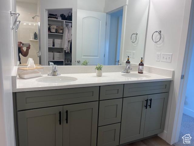 4542 Parkes Peak Ln, Riverton, UT 84096 - bathroom with double vanity, a spacious closet, and a shower