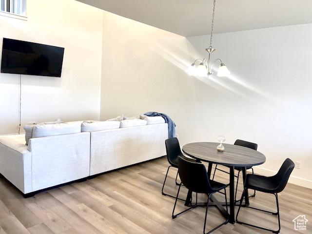 4542 Parkes Peak Ln, Riverton, UT 84096 - dining space with a chandelier and light wood-type flooring