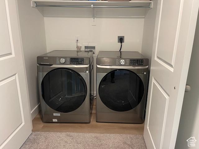 4542 Parkes Peak Ln, Riverton, UT 84096 - washroom with washer and clothes dryer and light colored carpet