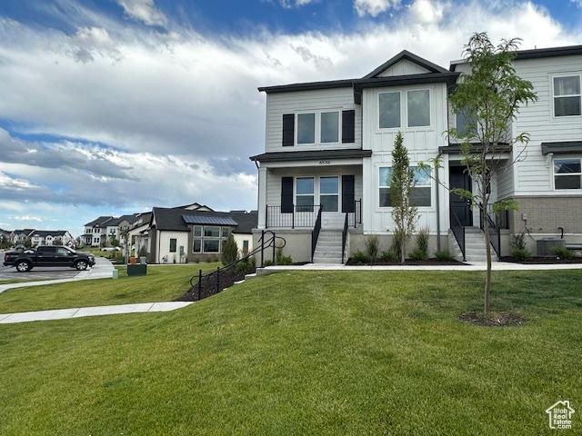 4542 Parkes Peak Ln, Riverton, UT 84096 - view of front of home with a front yard and board and batten siding