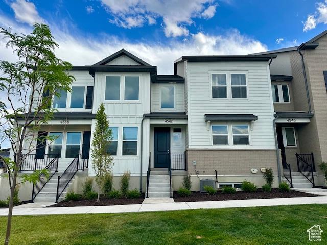 4542 Parkes Peak Ln, Riverton, UT 84096 - multi unit property with brick siding, a front yard, and board and batten siding